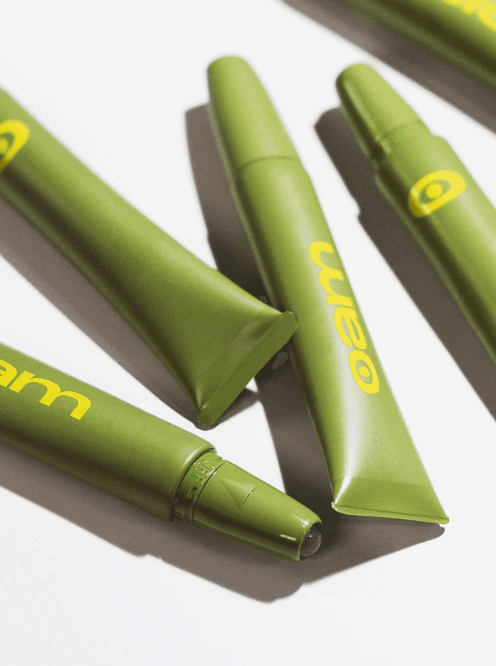 Green eyem elixirs lying on a white surface.